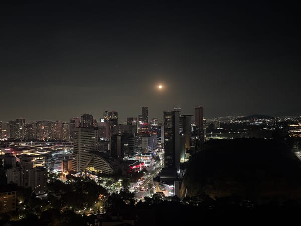 Full moon illuminates Mexico City skyline at night
