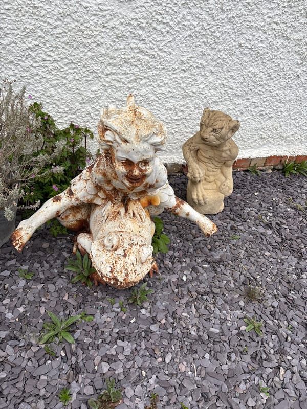 Garden statues observed in Minsterley countryside setting