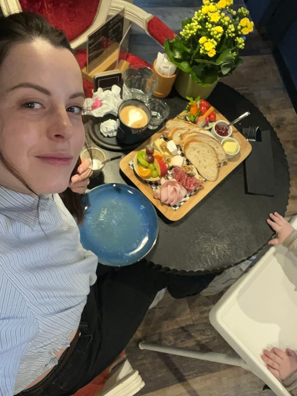 Woman enjoys elaborate breakfast charcuterie board in Meisenheim