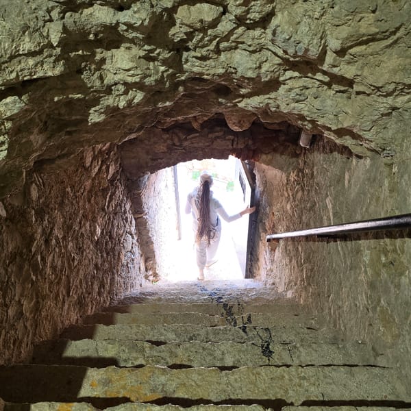 Stone tunnel complex with arched chambers documented by witness