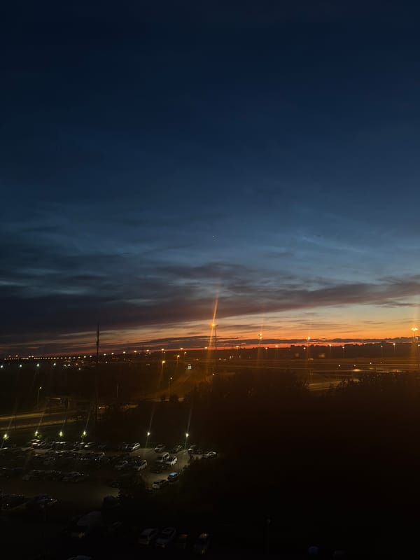City skyline at dusk, orange-to-navy sky across multiple angles