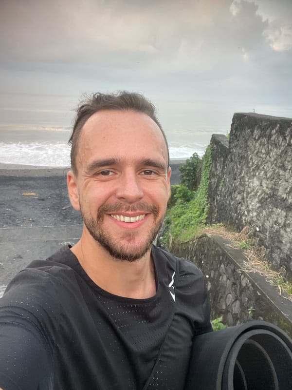 Moody black sand beach in Kediri under overcast skies
