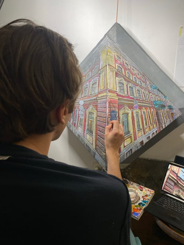 Saint Petersburg artist paints city buildings, dog naps alongside