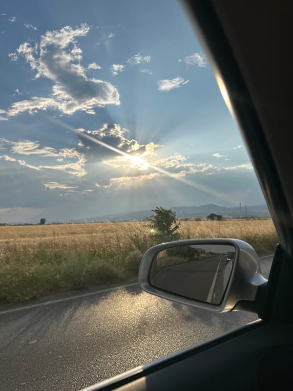 Rolling past golden fields and industry outside Sliven, Bulgaria