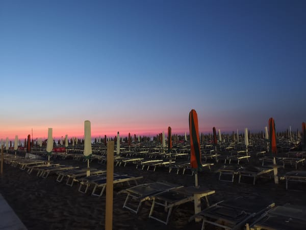 Rimini beach at dawn, quiet shores and pastel skies