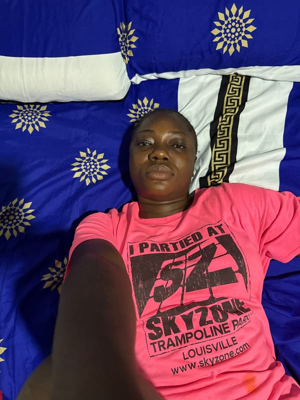 Person rests on patterned bed in Abuja evening