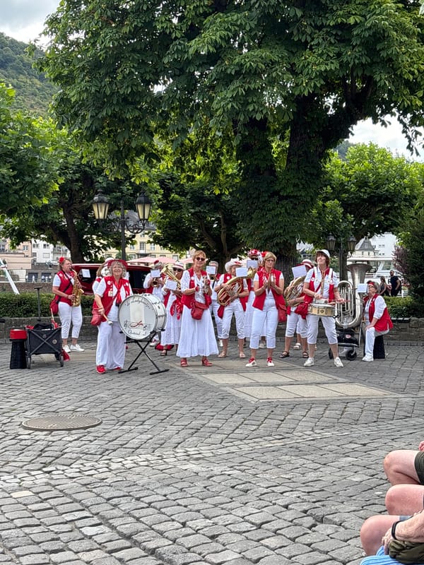 Brass band performs in Cochem's cobblestone plaza by the Moselle