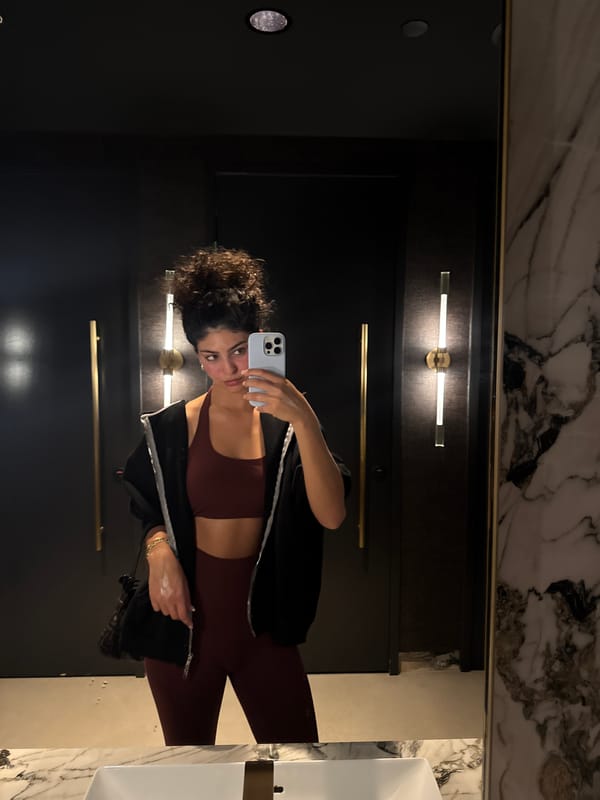 Woman takes selfie in West Hollywood commercial bathroom