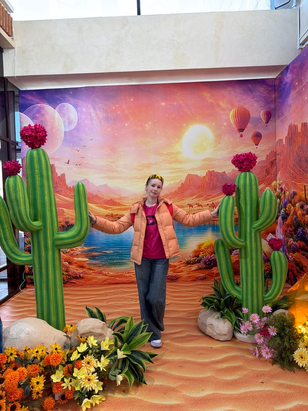 Person poses with desert-themed art installation in Berezniki