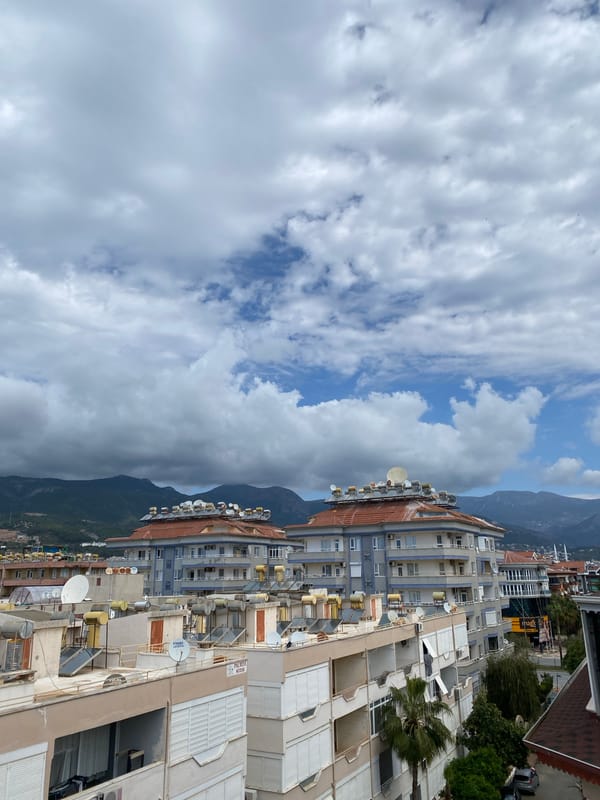 Morning rooftop views document Alanya residential district under cloudy skies