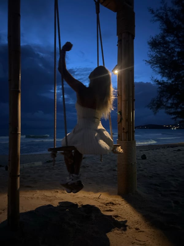 Stormy dusk on a Choeng Thale beach — swings, horses, and resort vibes