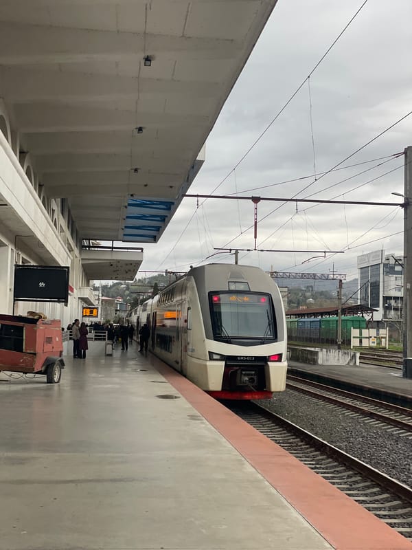 Train journey documented along Batumi's overcast coastline