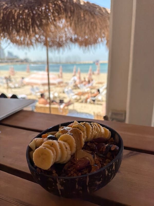Coconut shell smoothie bowl with banana served in Tel Aviv