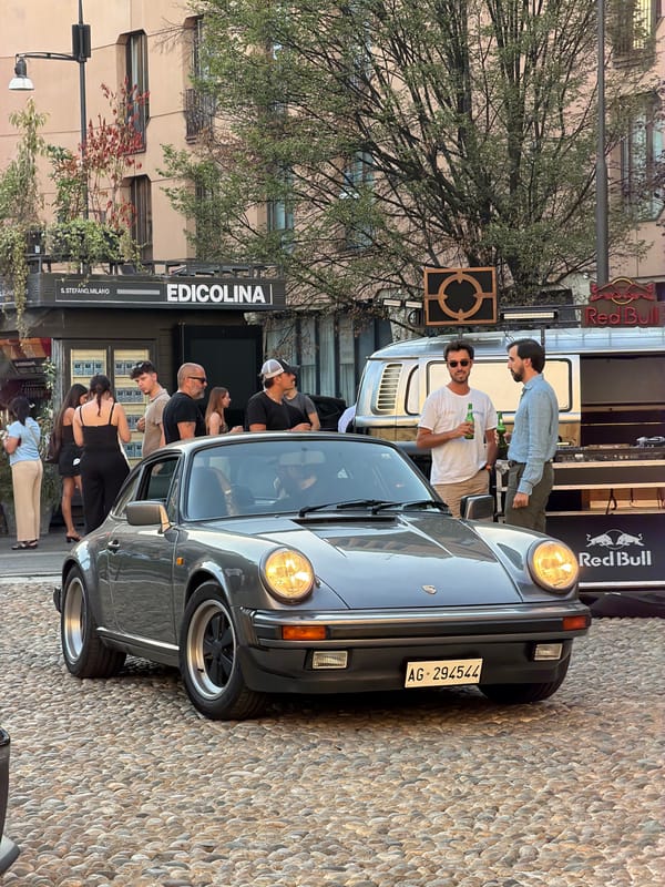 Classic car meetup on Milan cobblestones at golden hour