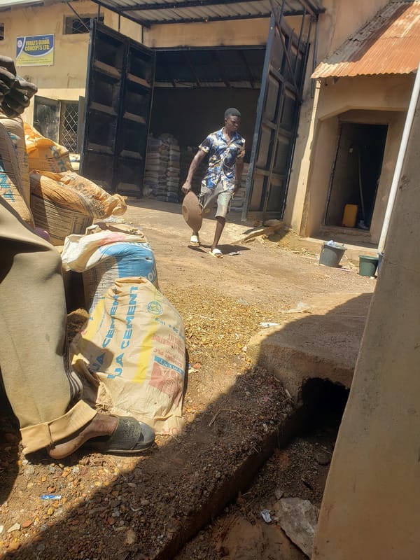 Workers handle cement bags at Jos warehouse during morning operations
