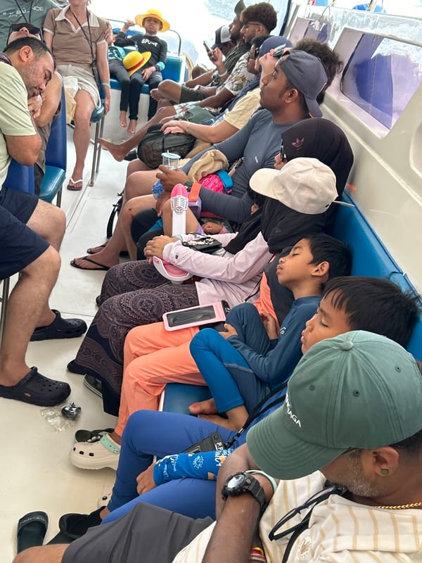 Boat passengers rest during early morning journey near Rawai