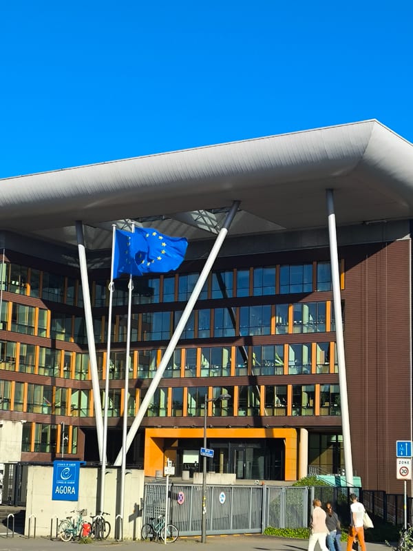 Tourist documents European Parliament buildings, pedestrians in Strasbourg