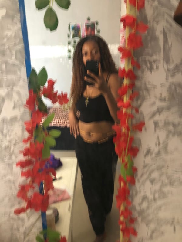 Woman Takes Mirror Selfie With Floral Decoration