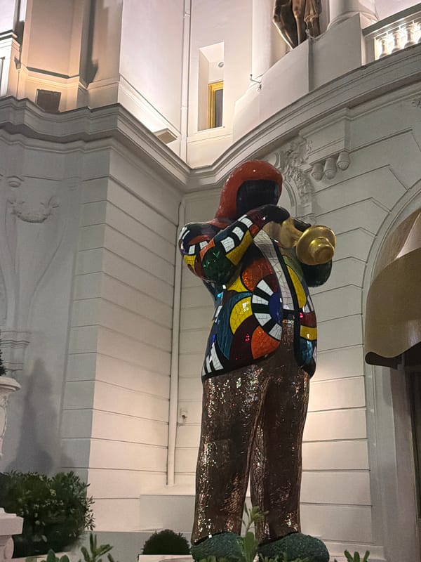Colorful sculpture and classical architecture documented in Nice evening