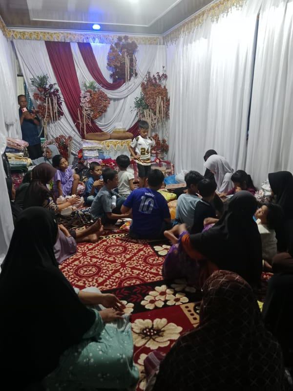 Indoor social gathering with families documented at mystery coordinates