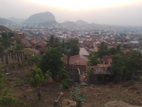 Aerial view captures dense city with mountain backdrop
