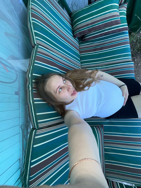 Selfie moment on a striped outdoor couch in Chaikovsky