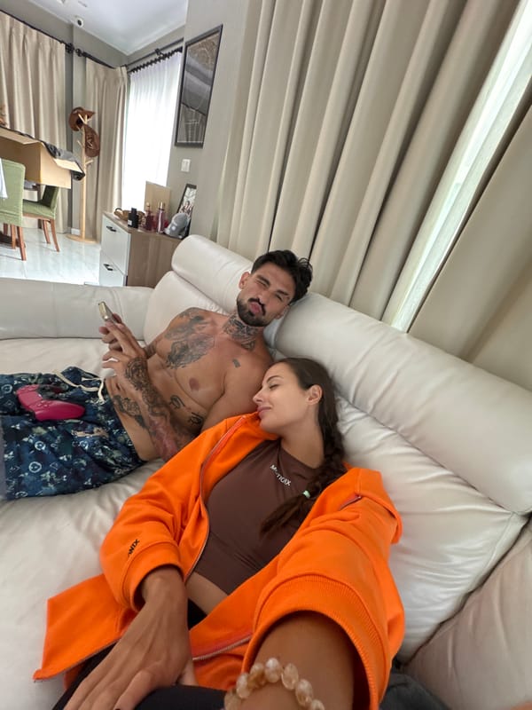 Couple relaxes on couch in Chalong, Thailand morning scene