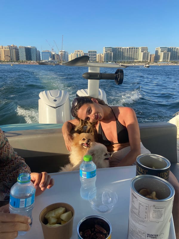 Woman with dog enjoys boat ride in Dubai waters