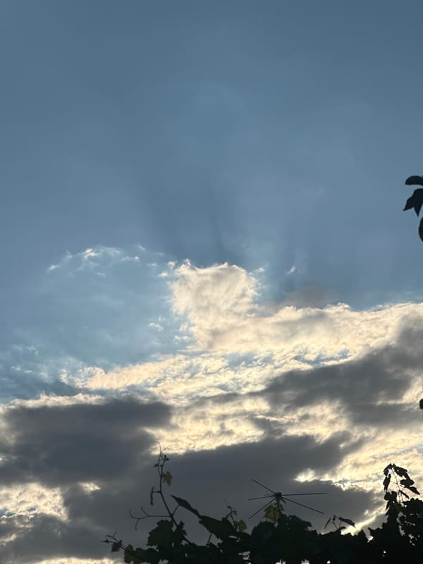 Dramatic sky and antenna silhouettes over Kogon City
