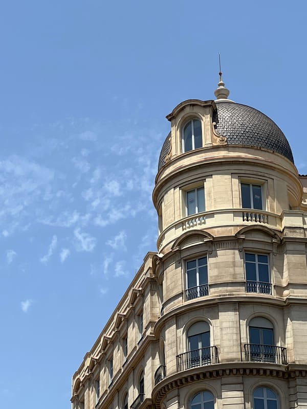 Ornate Barcelona building corner framed against a blue sky