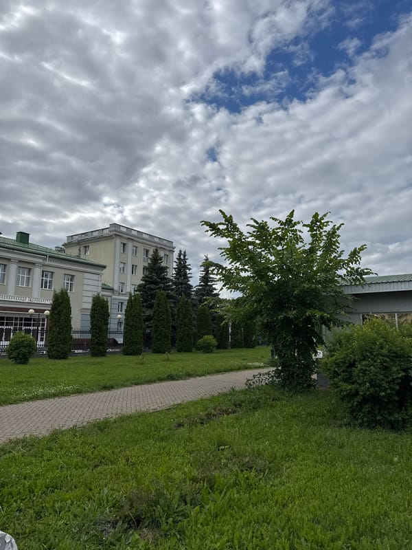 Everyday moments captured around historic building in Izhevsk park