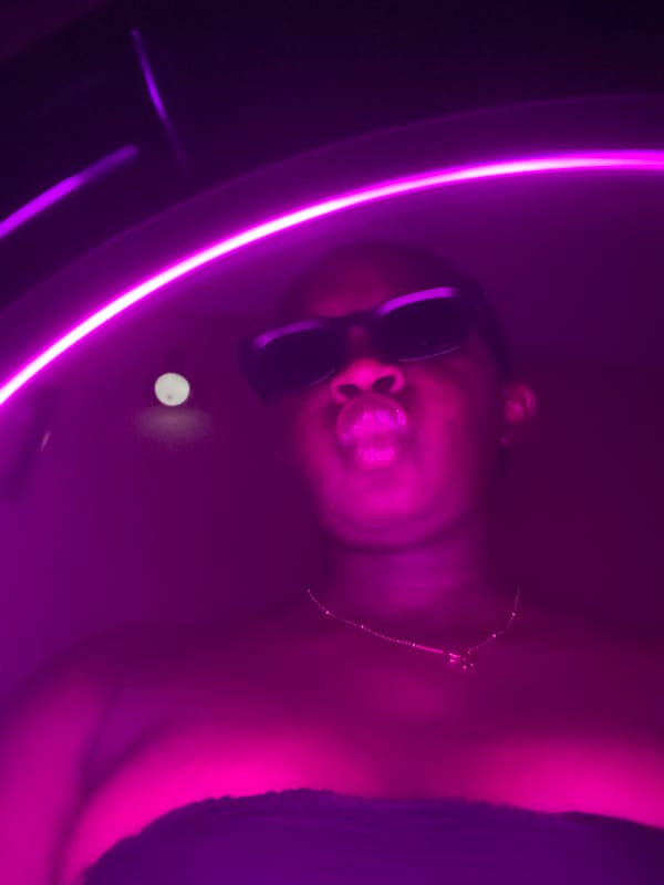 Person in illuminated tub under purple lighting in Nigeria