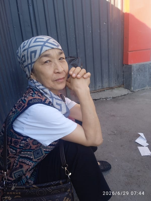 Ground-level details around a Cyrillic-script market, June 2026