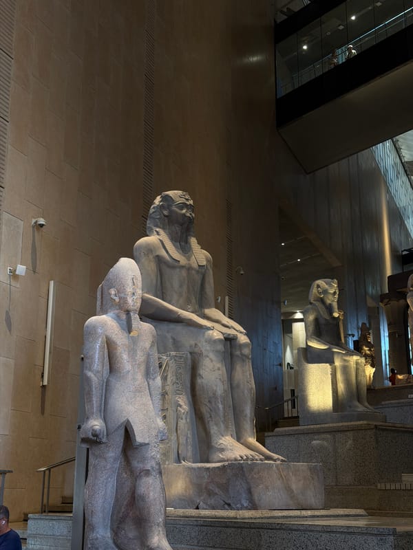 Inside the Grand Egyptian Museum with pharaohs and ancient stone