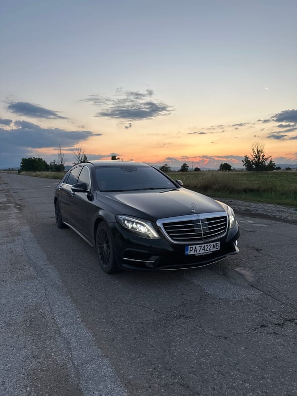 Black Mercedes S-Class spotted parked on cracked road at sunset