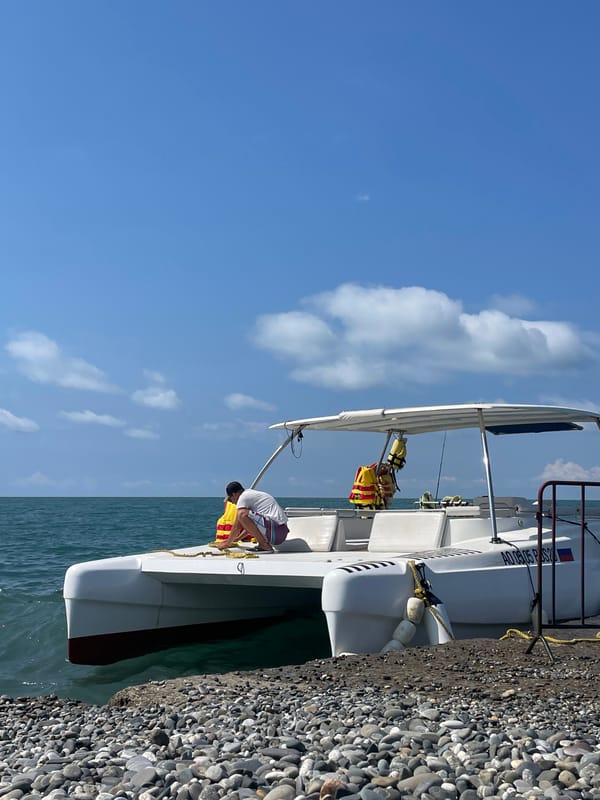 Catamaran docked on a pebble beach along the Russian Black Sea coast