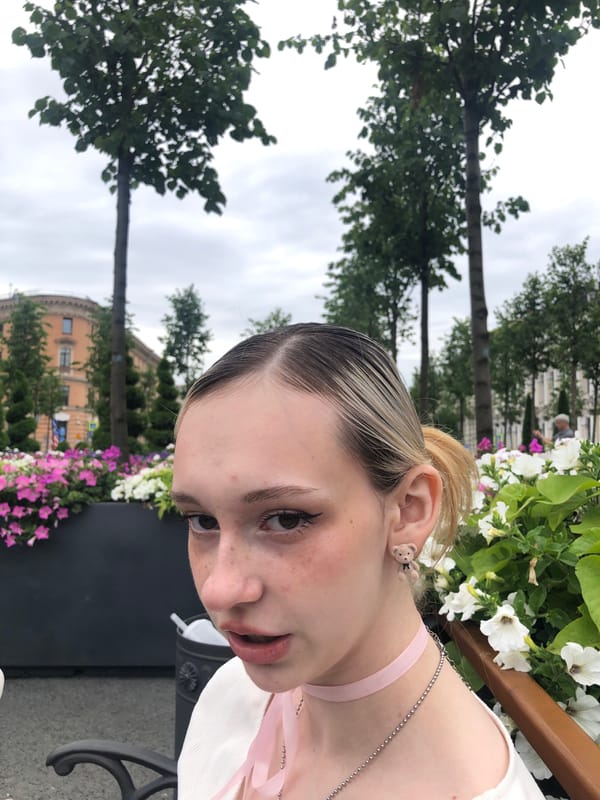 Selfies and street flowers outside a neoclassical building in Russia