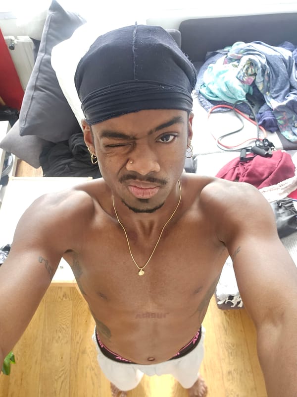 Person takes selfie wearing gold jewelry in Pantin