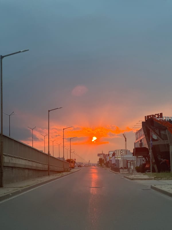 Sofia street glows under a dramatic summer sunset sky