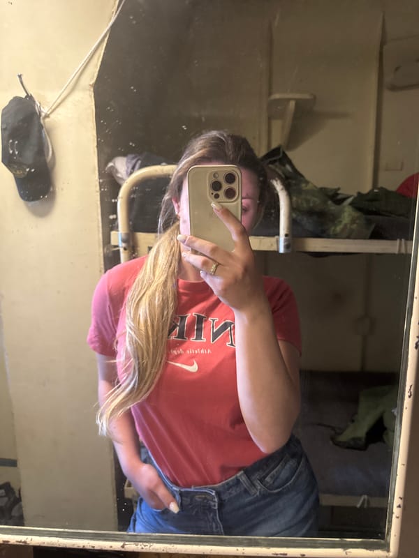 Woman takes mirror selfie in red shirt in Varna