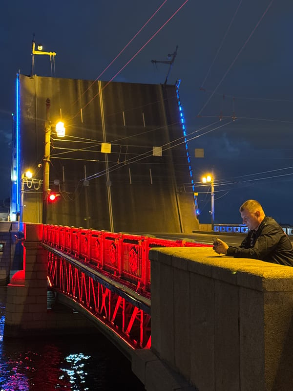 Night crowds gather at Saint Petersburg's illuminated Palace Bridge opening