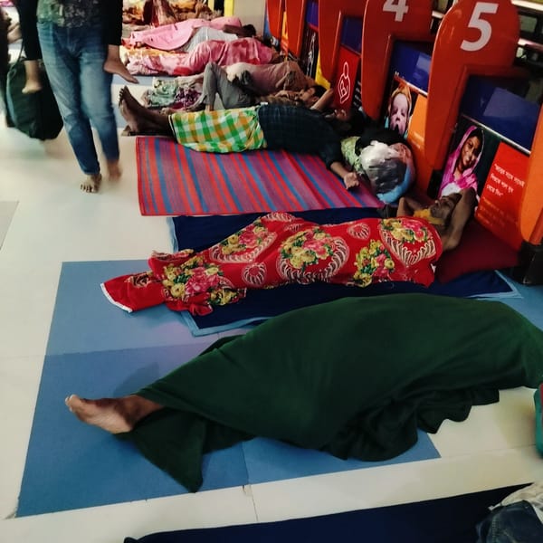People rest overnight in public building in Dhaka