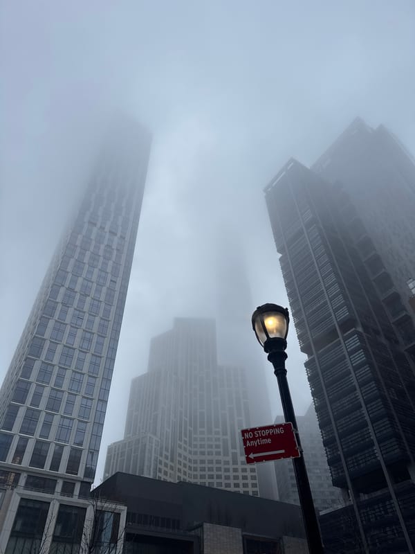 Dense fog blankets New York City streets, obscuring buildings