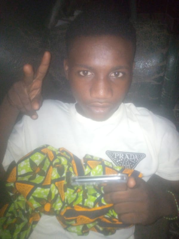 Young man photographed in Prada shirt at unknown location