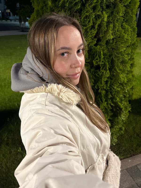 Woman Documents Illuminated Evening Walk in Novopokrovskaya, Russia