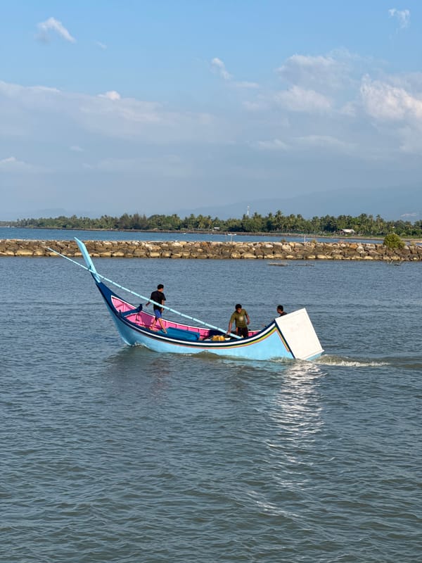 Traditional fishing boats work the waters off Reudeuep, Indonesia