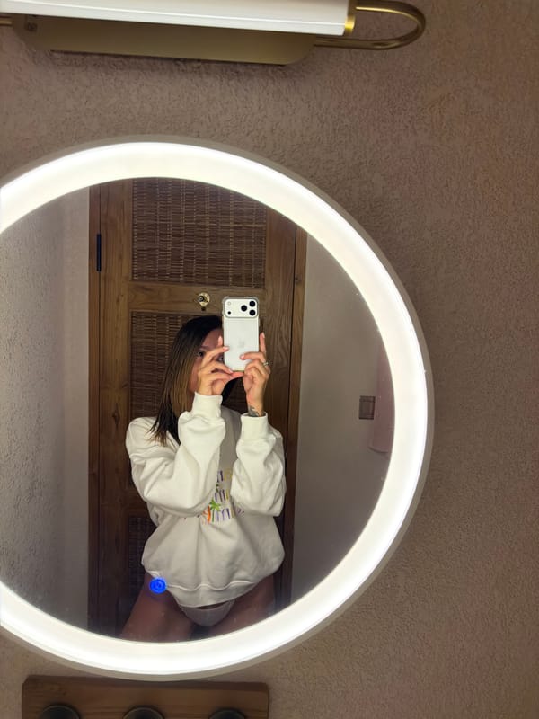 Woman takes bathroom selfies in illuminated mirror in Indonesia