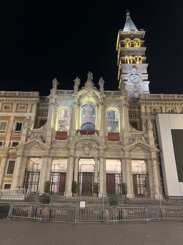Historic Rome basilica and bell tower illuminated at night