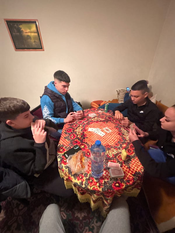 Young people play cards in Bulgarian living room