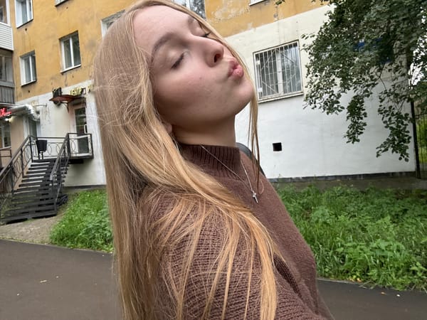 Selfie series in a Perm park, brown sweater and cross necklace